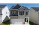 Charming two-story home featuring a two-car garage and neutral siding at 12040 Conrad Cir, Hampton, GA 30228
