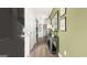 Inviting hallway showcasing hardwood floors, neutral walls, and decor and providing access to the kitchen at 12040 Conrad Cir, Hampton, GA 30228