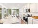 Stylish kitchen featuring granite counters, modern appliances, and lots of natural light from the adjacent dining area at 12040 Conrad Cir, Hampton, GA 30228