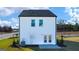 New construction rear exterior with white siding, lawn and blue sky background at 12040 Conrad Cir, Hampton, GA 30228