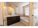 Bathroom featuring a double vanity and a soaking tub under a window at 3526 Brockenhurst Dr, Buford, GA 30519