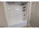 Bathroom shower-tub combination with white shower-tub and modern fixtures at 3526 Brockenhurst Dr, Buford, GA 30519