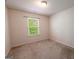 Neutral carpeted bedroom with a large window and an air vent at 3526 Brockenhurst Dr, Buford, GA 30519