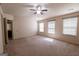 Spacious bedroom features natural light, a ceiling fan, and neutral carpeting at 3526 Brockenhurst Dr, Buford, GA 30519