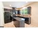 Well-lit kitchen features an island, black appliances, and granite countertops at 3526 Brockenhurst Dr, Buford, GA 30519