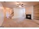Spacious living room featuring carpet, ceiling fan, fireplace, and built in shelving at 3526 Brockenhurst Dr, Buford, GA 30519