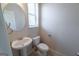 Half bath features a pedestal sink and window for natural light at 3526 Brockenhurst Dr, Buford, GA 30519