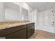 This bathroom features granite counters, a white sink, and a modern dark vanity at 1144 Bluecoat Cir, Hampton, GA 30228