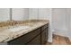 Bathroom featuring double sinks, granite counters, and a bathtub/shower at 1144 Bluecoat Cir, Hampton, GA 30228
