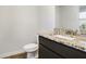 This bathroom features granite counters, a white sink, and a modern dark vanity at 1144 Bluecoat Cir, Hampton, GA 30228