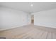 Spacious carpeted bedroom with neutral walls and a view to the hallway at 1144 Bluecoat Cir, Hampton, GA 30228