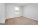 Bedroom with carpeted flooring, bright light, and views from the window at 1144 Bluecoat Cir, Hampton, GA 30228