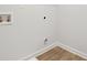 Utility room features laminate floors with white trim, water hookups, and white walls at 1144 Bluecoat Cir, Hampton, GA 30228