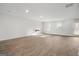Open living room with wood-look floors, and a modern fireplace at 1144 Bluecoat Cir, Hampton, GA 30228