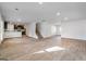 Spacious living room features wood flooring and connects to the kitchen and staircase at 1144 Bluecoat Cir, Hampton, GA 30228