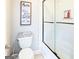 Bathroom with toilet and glass door over tub/shower combo at 109 Lighthorse Blvd, Mcdonough, GA 30252