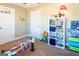 Bright bedroom featuring a built-in bookshelf and carpeted floor, perfect for play and relaxation at 109 Lighthorse Blvd, Mcdonough, GA 30252