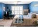 Stylish bedroom with blue accent wall, a desk and comfy bed creating a relaxing space for sleep or study at 109 Lighthorse Blvd, Mcdonough, GA 30252