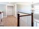 Upstairs landing with chandelier lighting and view of the foyer below at 109 Lighthorse Blvd, Mcdonough, GA 30252