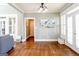 Open-concept living room with hardwood floors and lots of natural light at 109 Lighthorse Blvd, Mcdonough, GA 30252