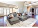 Bright and open living room area connected to the kitchen, featuring a large sectional and hardwood floors at 109 Lighthorse Blvd, Mcdonough, GA 30252