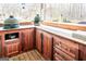 Outdoor kitchen with rich wood cabinets, counter space, and built-in grill, perfect for outdoor cooking and entertaining at 109 Lighthorse Blvd, Mcdonough, GA 30252