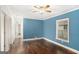 Bedroom with blue walls, hardwood flooring, ceiling fan, and natural lighting from the window at 3378 La Vista, Hapeville, GA 30354