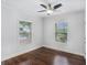 Bedroom with neutral walls, hardwood floors, ceiling fan, and two windows overlooking the yard at 3378 La Vista, Hapeville, GA 30354