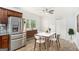 Bright dining area with a table, chairs, stainless refrigerator, and modern decor at 3378 La Vista, Hapeville, GA 30354