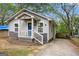 Quaint one-story home with a welcoming porch, accented by a star decoration above the blue front door at 3378 La Vista, Hapeville, GA 30354