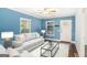 Comfortable living room with bright blue walls, ceiling fan, and lots of natural light at 3378 La Vista, Hapeville, GA 30354