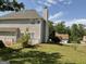 Side yard with a view of the exterior of a two-story home with white railing and brick chimney at 1028 Field View Dr, Mcdonough, GA 30253