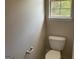 Standard bathroom with a toilet near a window at 1028 Field View Dr, Mcdonough, GA 30253