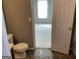 View from the bathroom doorway into a bedroom featuring beige walls and bright window at 1028 Field View Dr, Mcdonough, GA 30253