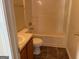 An up-close view of a bathroom, featuring a white toilet, tub and vanity with a sink at 1028 Field View Dr, Mcdonough, GA 30253