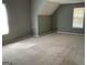 An angled view of a spacious bedroom, featuring neutral-colored walls and carpet, with a window at 1028 Field View Dr, Mcdonough, GA 30253