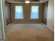 Expansive bedroom with large windows and neutral carpeting at 1028 Field View Dr, Mcdonough, GA 30253