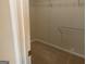 A partially open walk-in closet with white walls, beige carpet and wire rack shelf at 1028 Field View Dr, Mcdonough, GA 30253