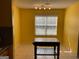 Bright dining area featuring an island, yellow walls, and tile flooring at 1028 Field View Dr, Mcdonough, GA 30253