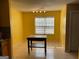 Bright dining area featuring an island, yellow walls, and tile flooring at 1028 Field View Dr, Mcdonough, GA 30253