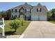 Traditional two-story home with a well-maintained lawn and a two-car garage at 1028 Field View Dr, Mcdonough, GA 30253