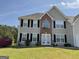 Charming two-story home with vinyl siding, brick accents, and a well-manicured lawn at 1028 Field View Dr, Mcdonough, GA 30253