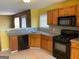 This kitchen features wood cabinets, granite countertops, and stainless steel appliances at 1028 Field View Dr, Mcdonough, GA 30253