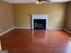 Spacious living room with wood floors, fireplace, and neutral-colored walls at 1028 Field View Dr, Mcdonough, GA 30253