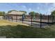 Community playground features slides and play equipment, enclosed with black fencing at 1028 Field View Dr, Mcdonough, GA 30253