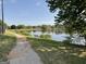Scenic community pond surrounded by trees and walking path with bench seating at 1028 Field View Dr, Mcdonough, GA 30253