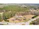 Aerial view of a home and land near a roundabout with beautiful, lush green trees surrounding the property at 315 S Bethany Rd, Mcdonough, GA 30252
