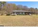 Single story home with a long covered carport and manicured greenery at 315 S Bethany Rd, Mcdonough, GA 30252