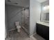 A bathroom featuring a glass shower, a toilet, and a dark vanity with a light countertop at 487 Eastside Dr, Dacula, GA 30019