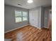 The bedroom features hardwood flooring, a double-door closet, and two windows at 487 Eastside Dr, Dacula, GA 30019
